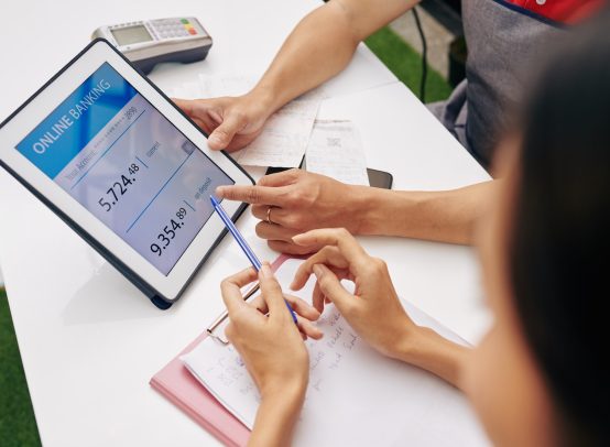 Coffeeshop owners checking bank account